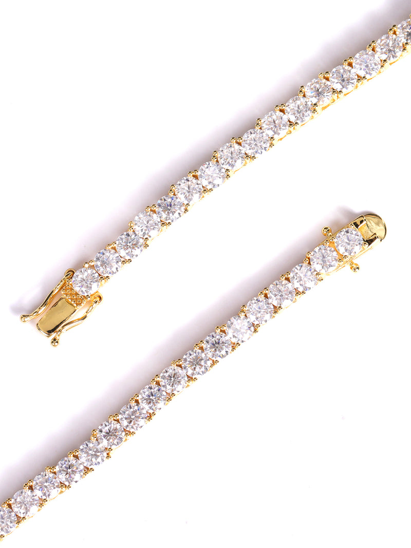 Gold bracelet with clear gemstones on a white background