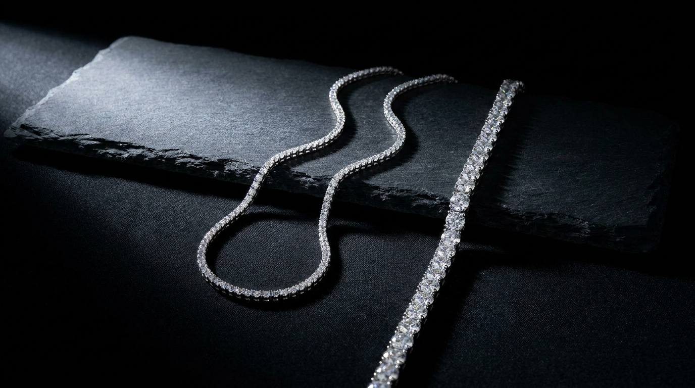 Moissanite tennis chains in two widths draped on dark slate for sizing comparison