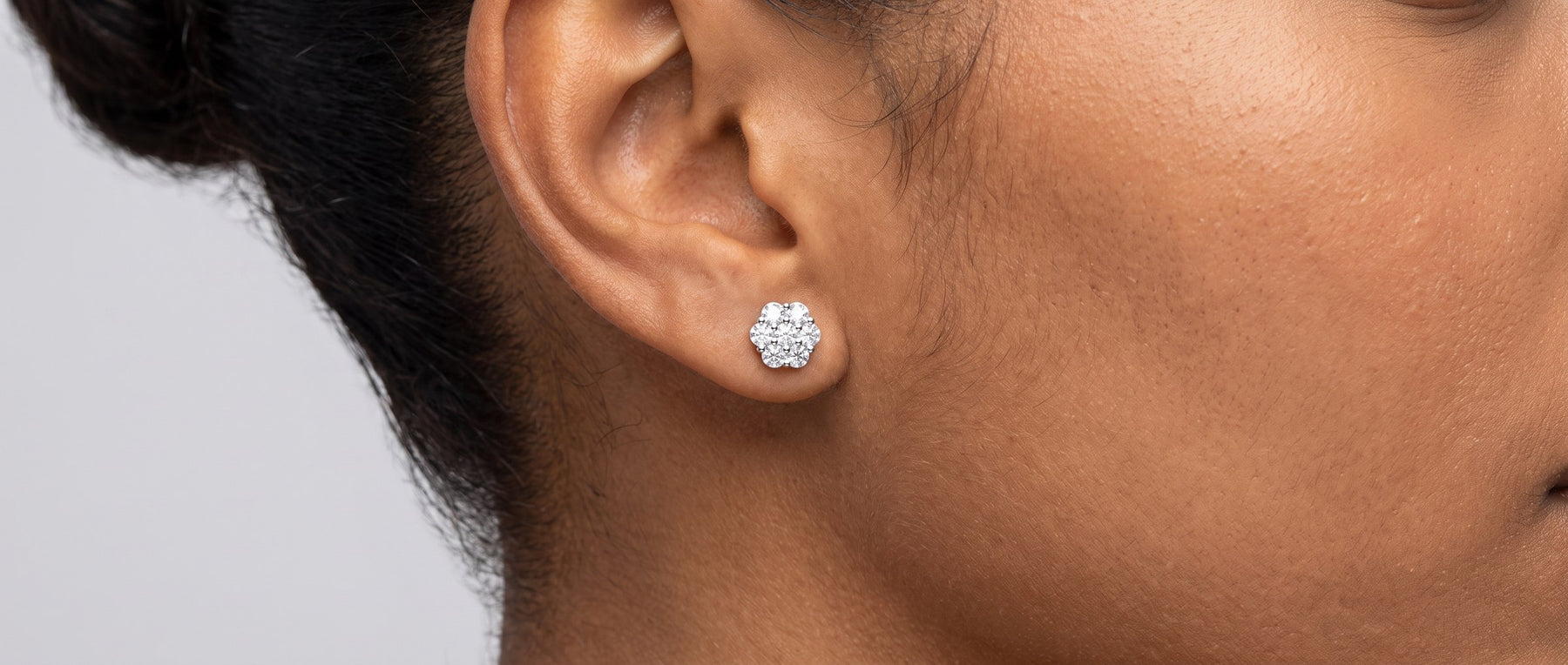 Moissanite cluster earrings from Jamilah Jewels, shown on the ear