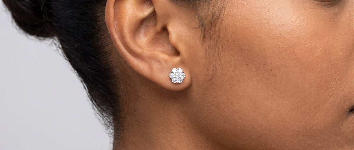Moissanite cluster earrings from Jamilah Jewels, shown on the ear