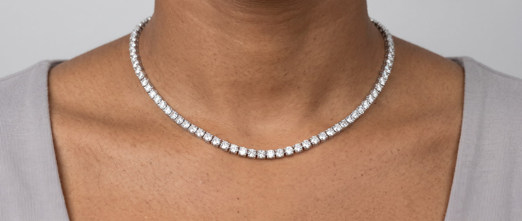 Moissanite tennis chains from Jamilah Jewels, worn at the neck