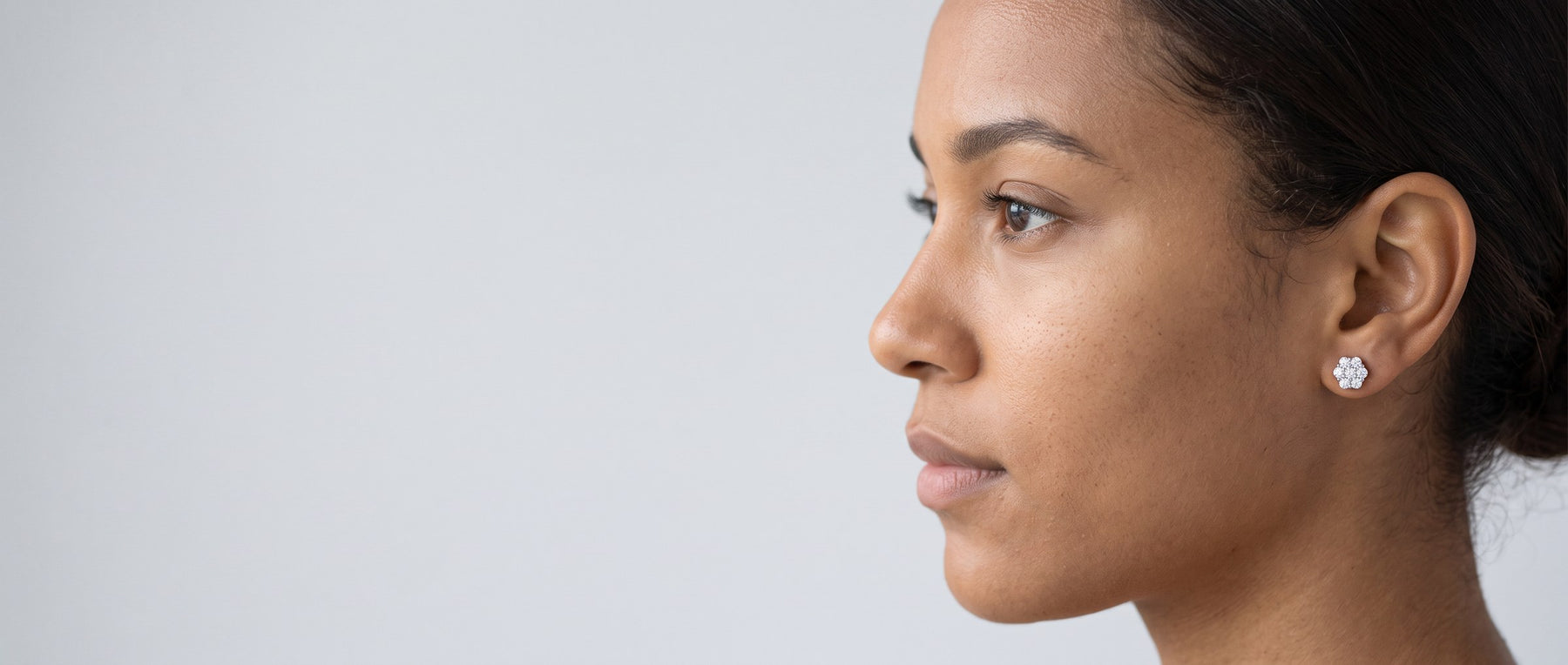 Moissanite earrings from Jamilah Jewels, shown on the ear