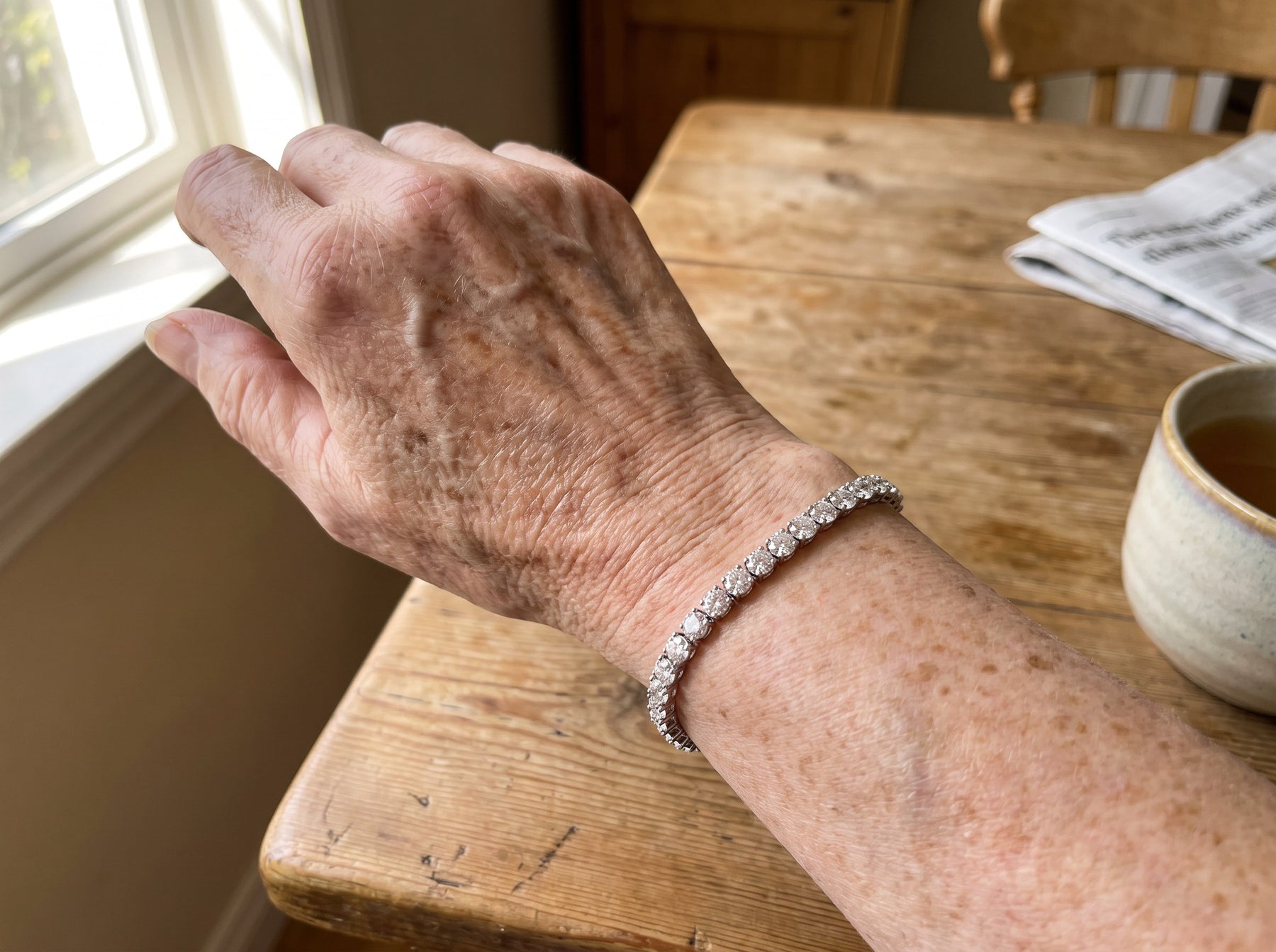 A woman wearing a moissanite tennis bracelet