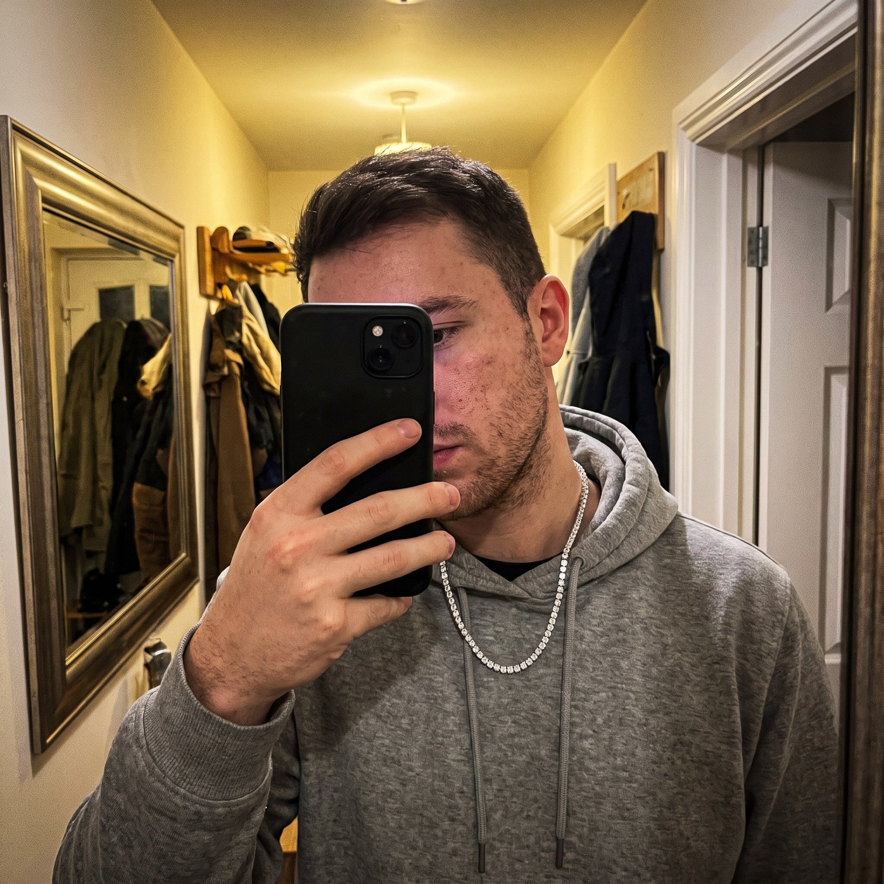 A moissanite chain worn, photographed in a mirror