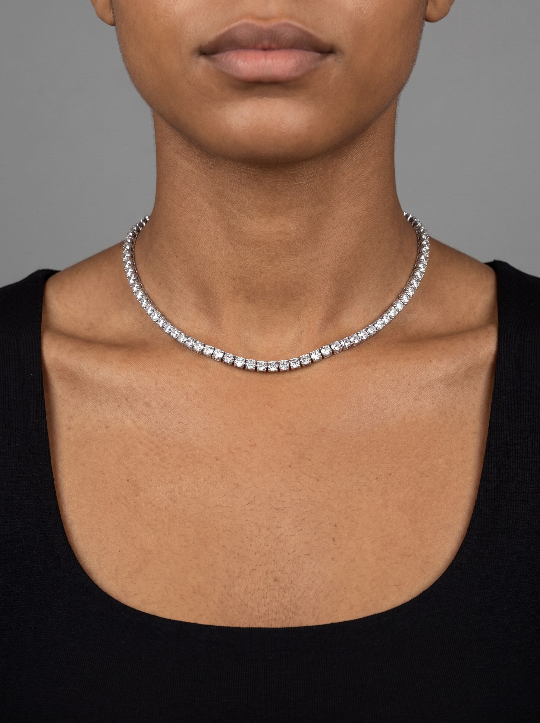 A moissanite tennis chain worn at 18 inches, sitting at the collarbone