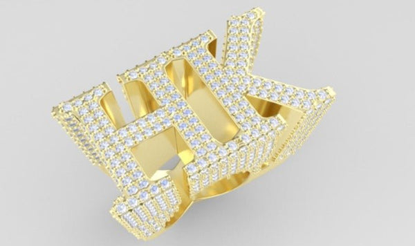 Gold ring with diamond-studded design on a light gray background