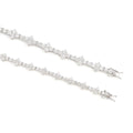Two white gold tennis bracelets with star-shaped links and sparkling diamonds are shown on a white background, echoing the elegance of the ‘True Hive’ Patterned Design Bracelet with their subtle hexagonal-inspired motif.