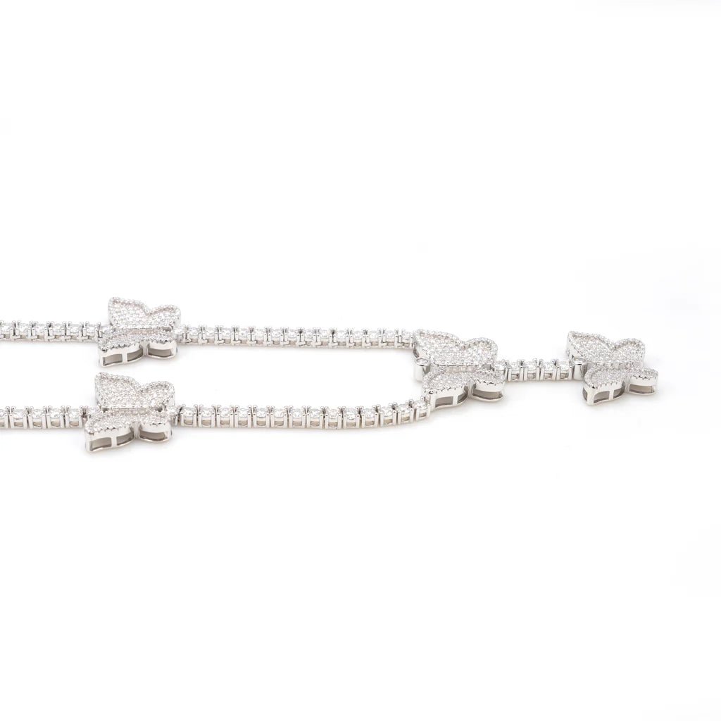 Close-up of a Butterfly 'Dreamline' Tennis Chain featuring sparkling moissanite stones set in a delicate silver design with butterfly-shaped accents.