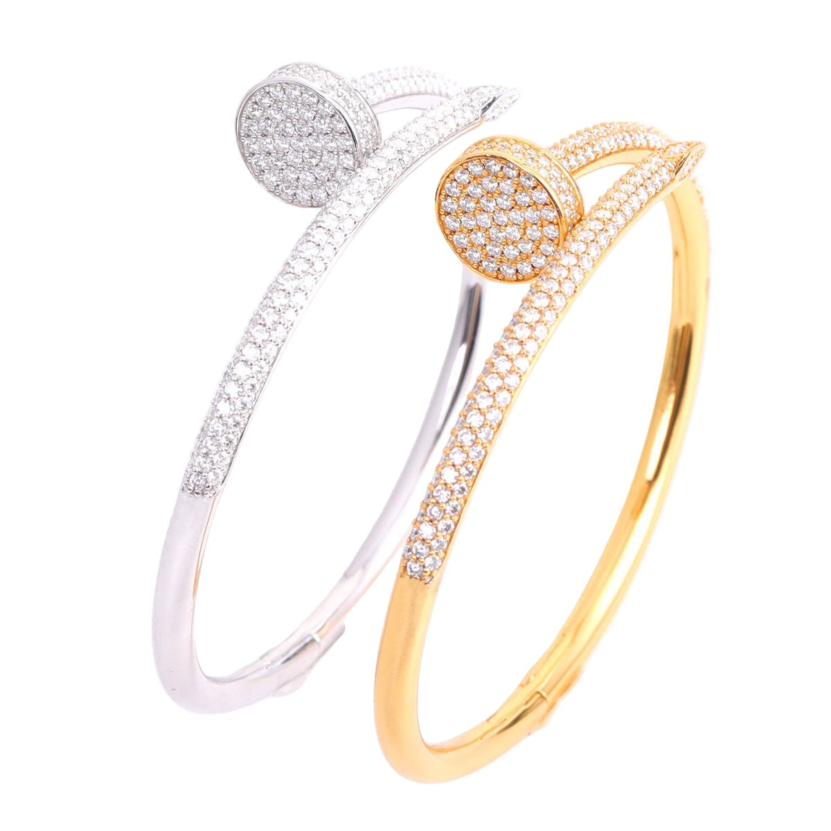 Gold and silver bangles with diamond-like stones on a white background