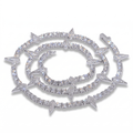 Close-up of a sparkling Rockstar Crown Spike Tennis Chain featuring alternating round stones and pointed spike accents in polished silver, exuding edgy elegance and luxury.