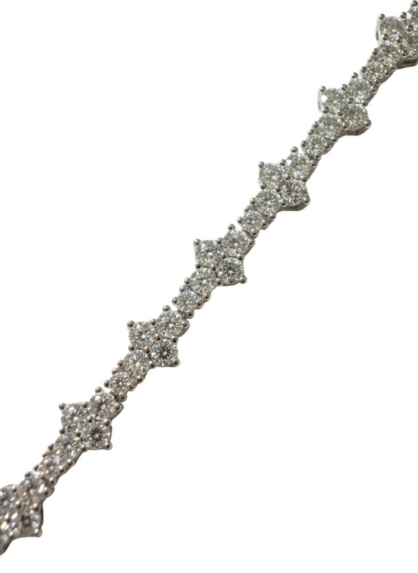 Silver bracelet with clear stones on a white background