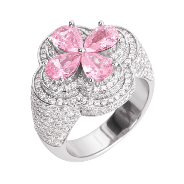 Silver ring with pink gemstones on a white background