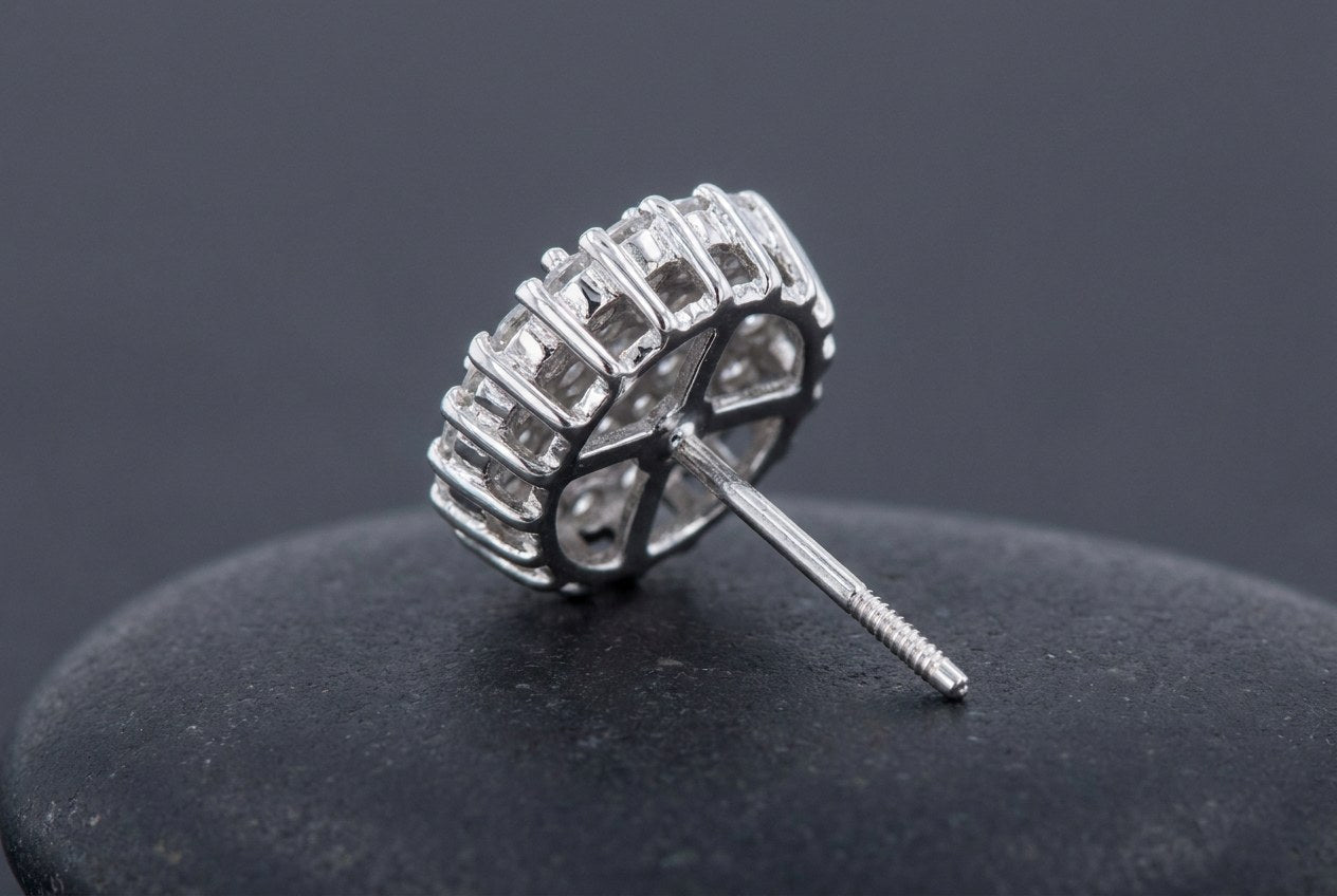 The underside of a sterling silver cluster stud earring showing the open gallery and the channels that run between the settings