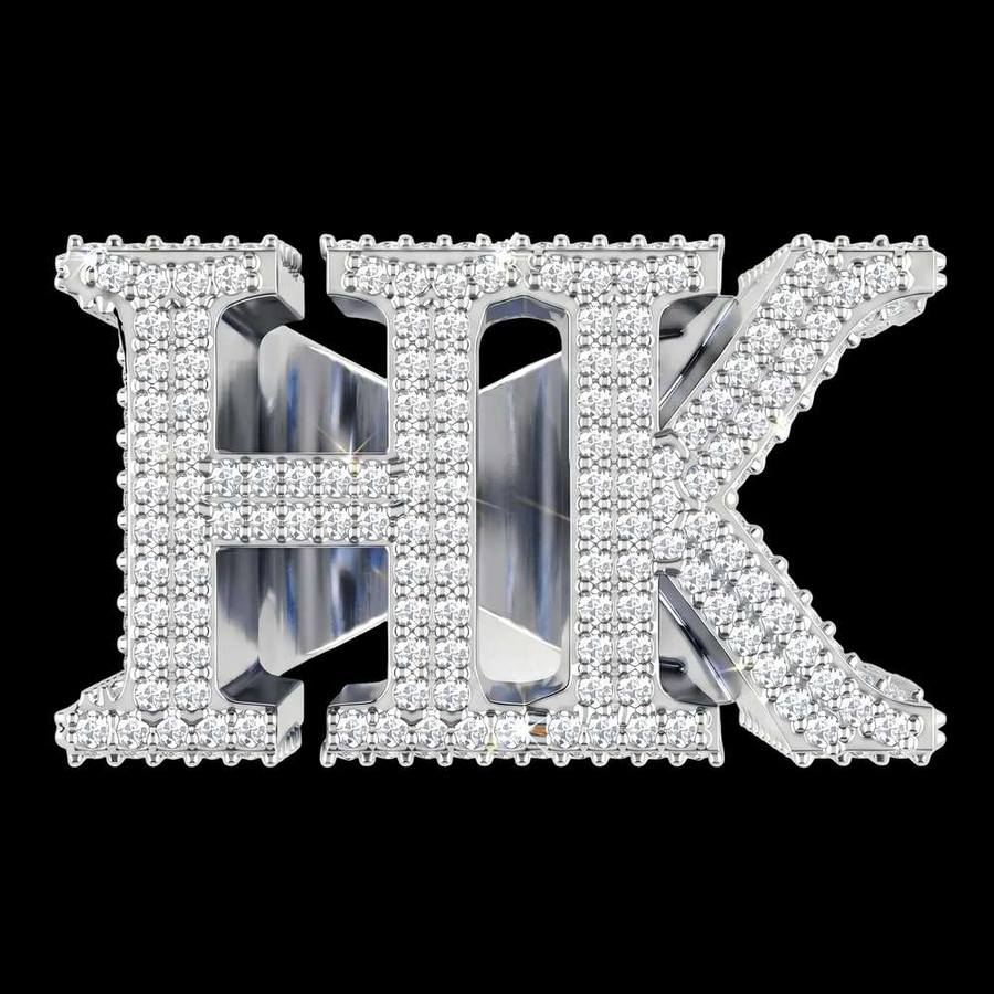 The Custom 'HK' Championship Pinky Ring by Jamilah Jewels is a silver pinky ring showcasing bold, diamond-encrusted HK letters on a plain white background.