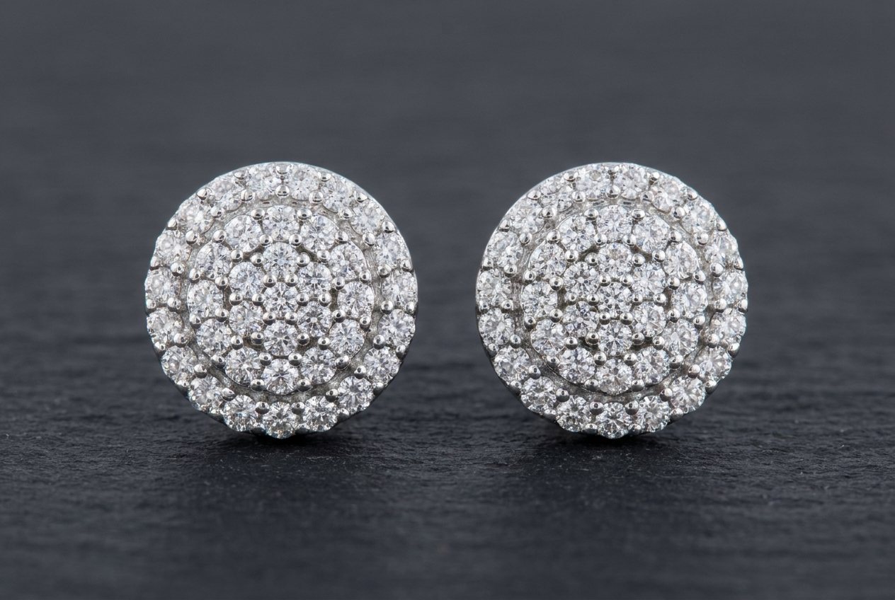 A pair of round moissanite cluster earrings in sterling silver on a dark surface