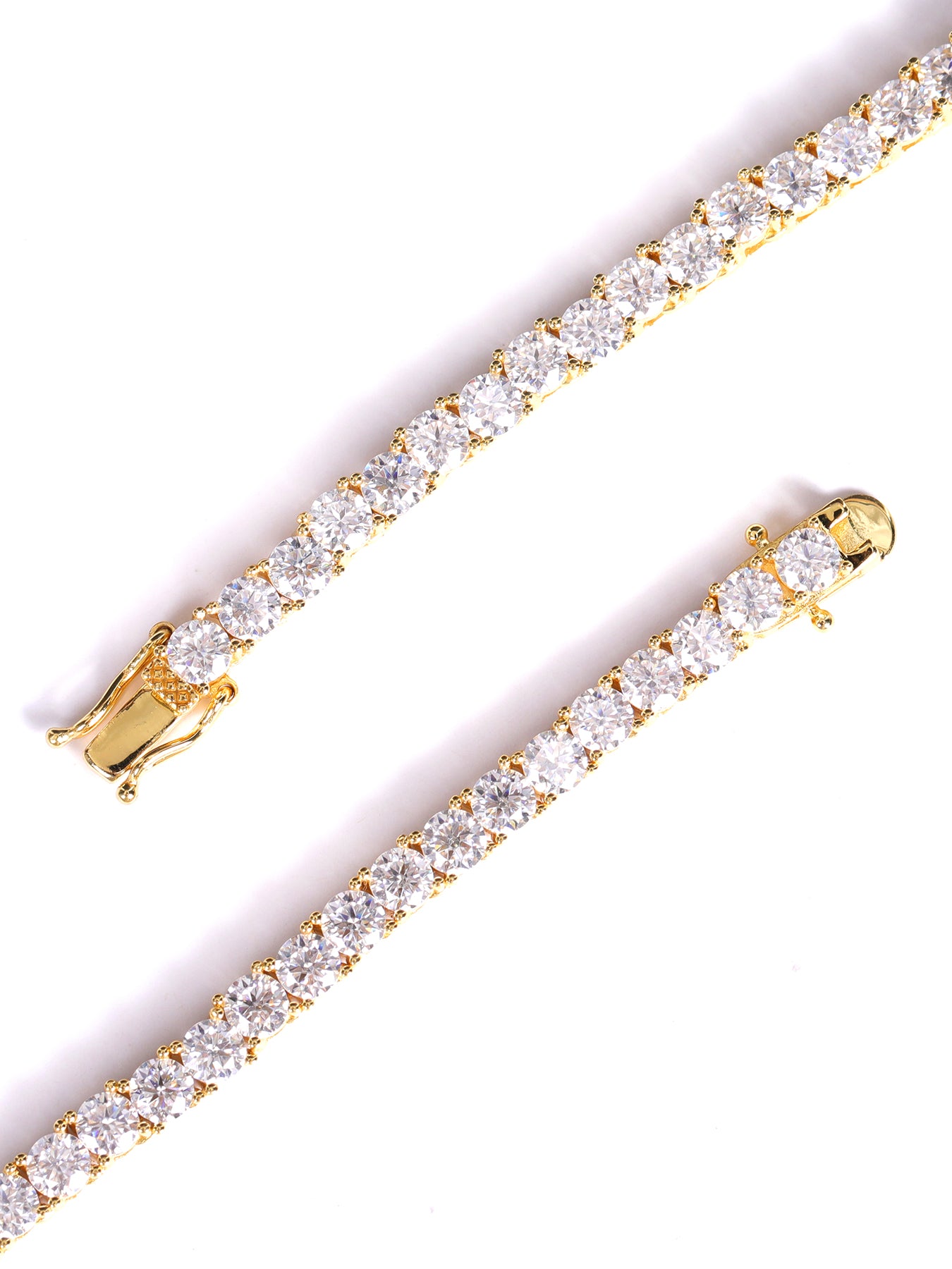 Gold bracelet with clear gemstones on a white background