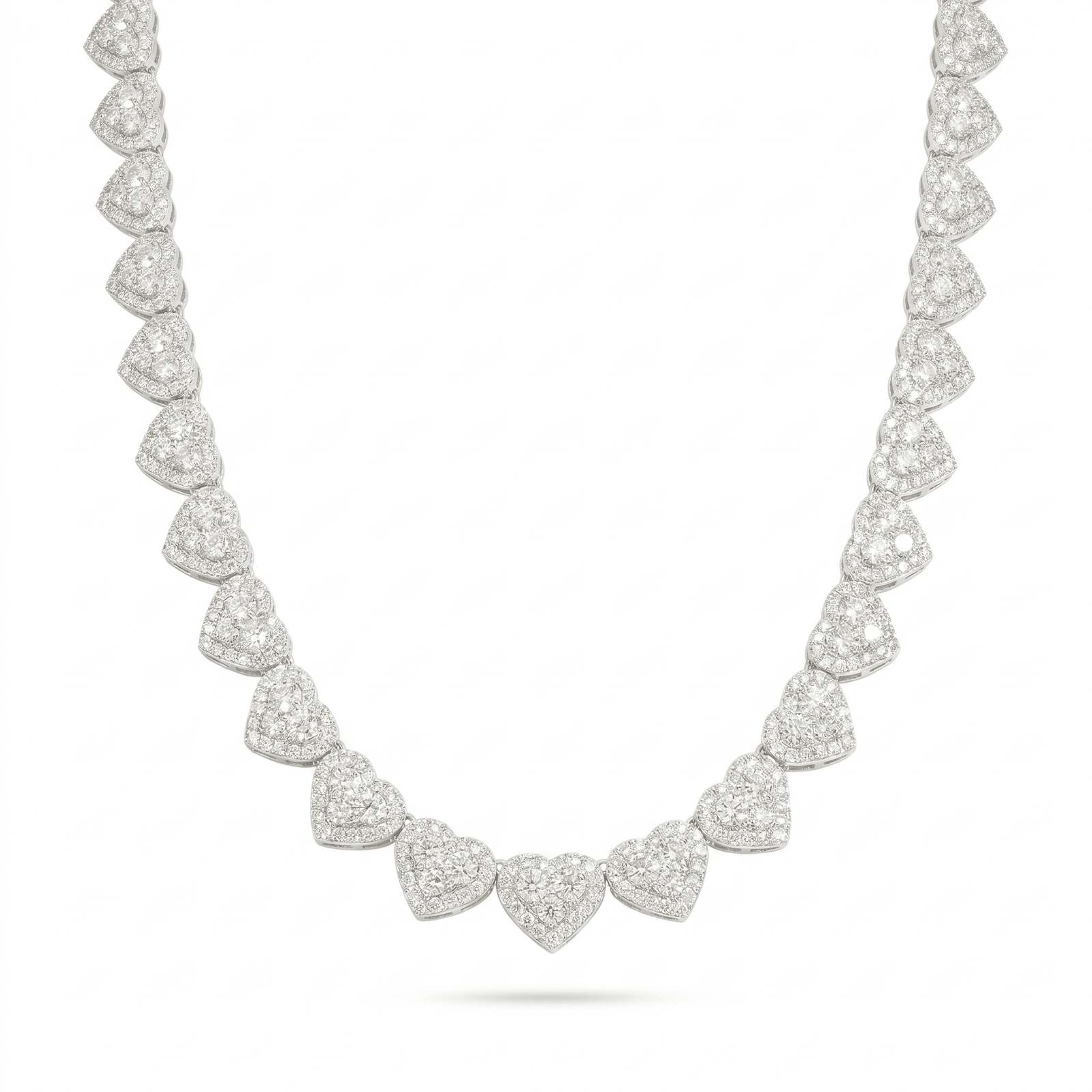 The 'Pure Affection' Linked Heart Chain is a sterling silver necklace with symmetrical heart-shaped clusters encrusted with sparkling VVS lab stones, creating an elegant and luxurious look on a white background.
