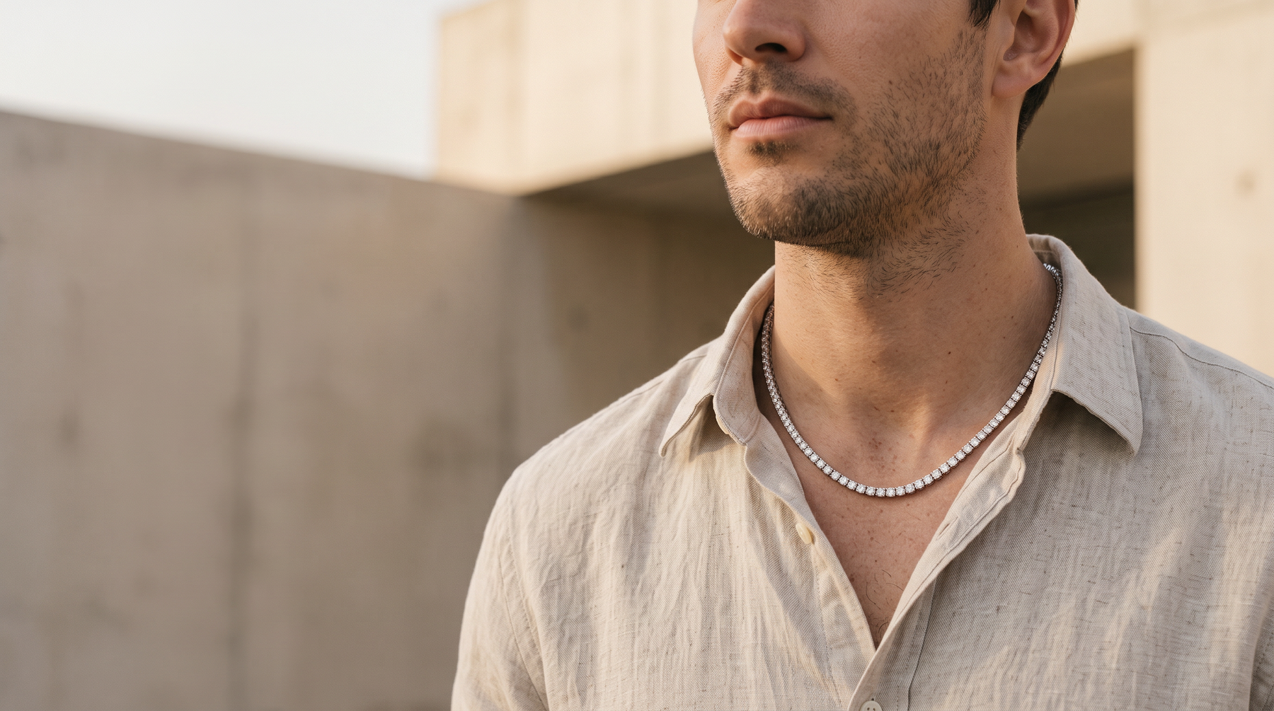 Man in an open linen shirt wearing a .925 sterling silver moissanite tennis chain from Jamilah Jewels