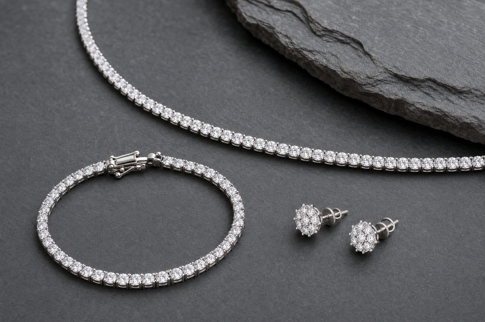 Moissanite tennis chain arranged with a matching tennis bracelet and starburst stud earrings as a coordinated set