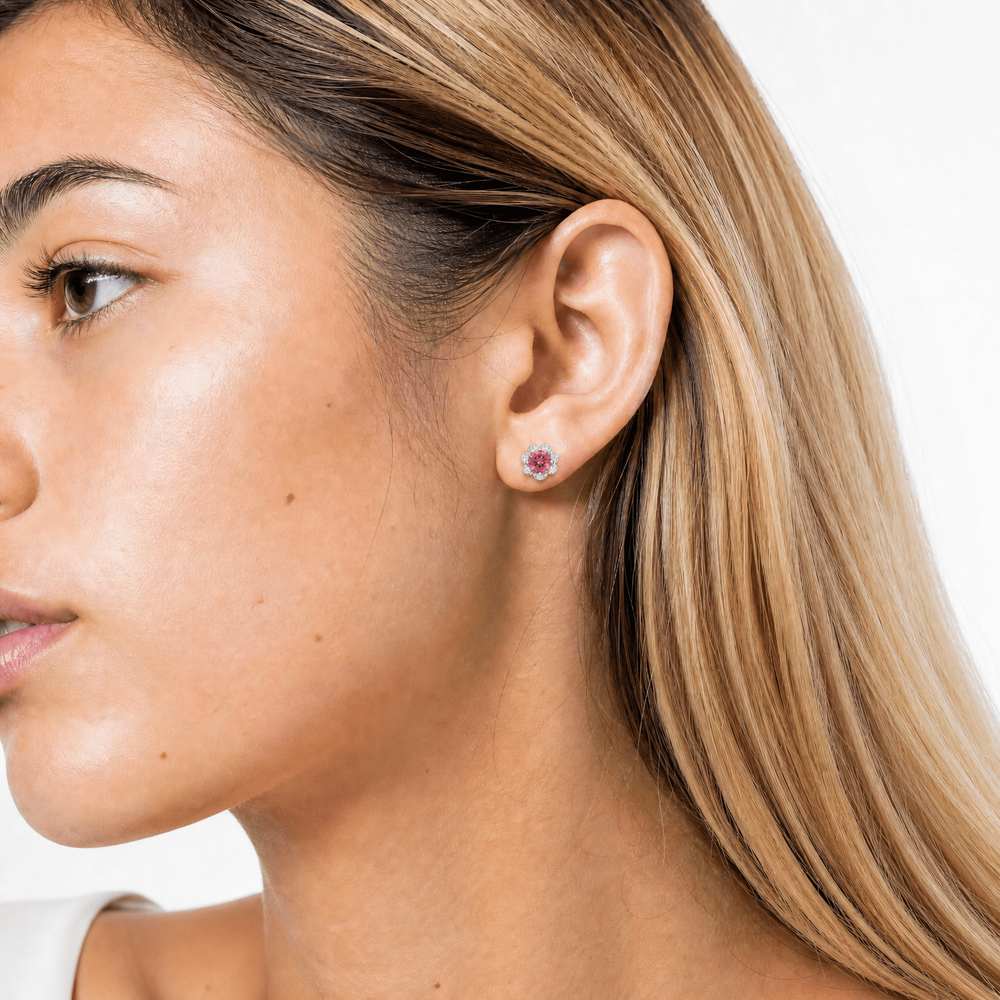 Close-up of a woman wearing delicate 'Rose Light' Petal Halo Earrings, showcasing their subtle floral design and elegant shine against her skin.