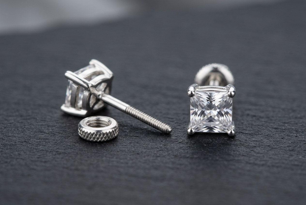 Sterling silver stud earring with a threaded screw-back post and matching screw-on nut beside a square-cut stone stud