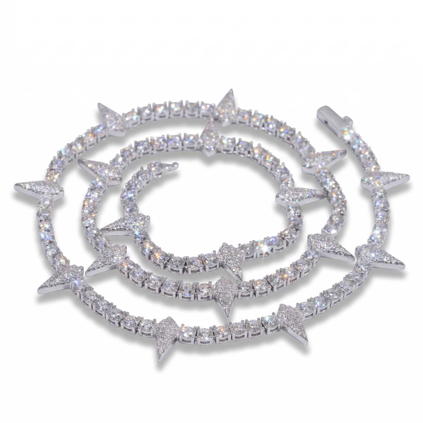 Close-up of a sparkling Rockstar Crown Spike Tennis Chain featuring alternating round stones and pointed spike accents in polished silver, exuding edgy elegance and luxury.