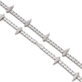 Close-up of a Rockstar Crown Spike Tennis Chain featuring silver links accented with crown-shaped spikes encrusted with small sparkling stones.