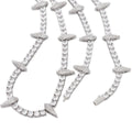 Close-up of a Rockstar Crown Spike Tennis Chain featuring clear stones set in a silver tone with spike-shaped accents along the chain.
