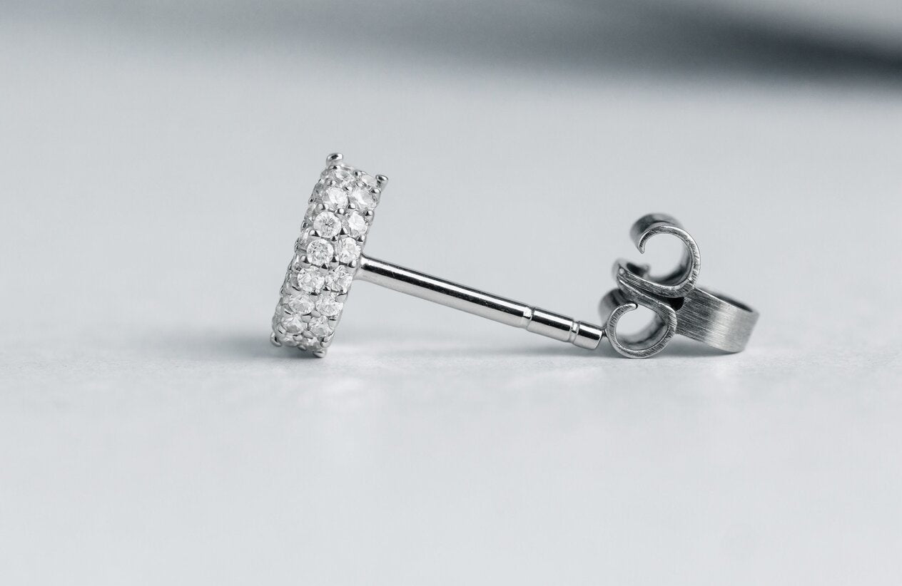 Close-up of a sterling silver stud earring showing its post and butterfly back